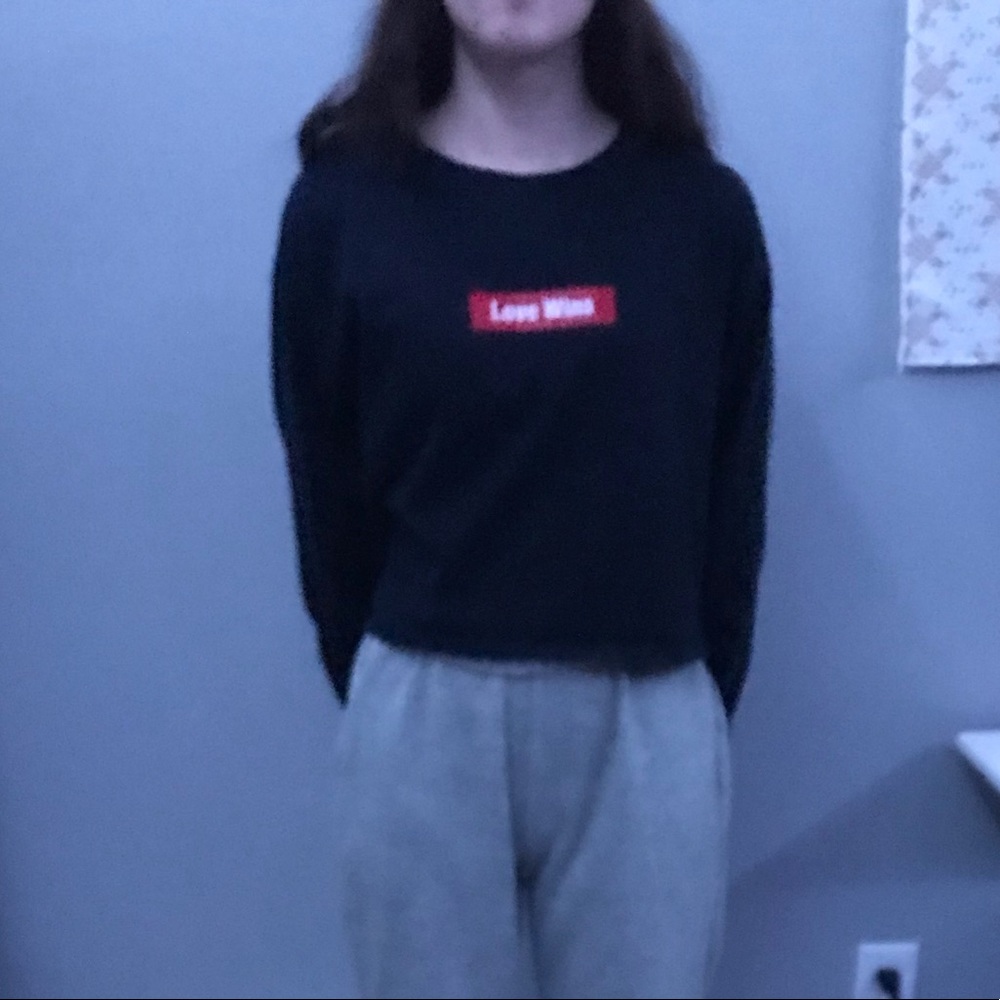 Navy blue long sleeve crop top wording “love wins”